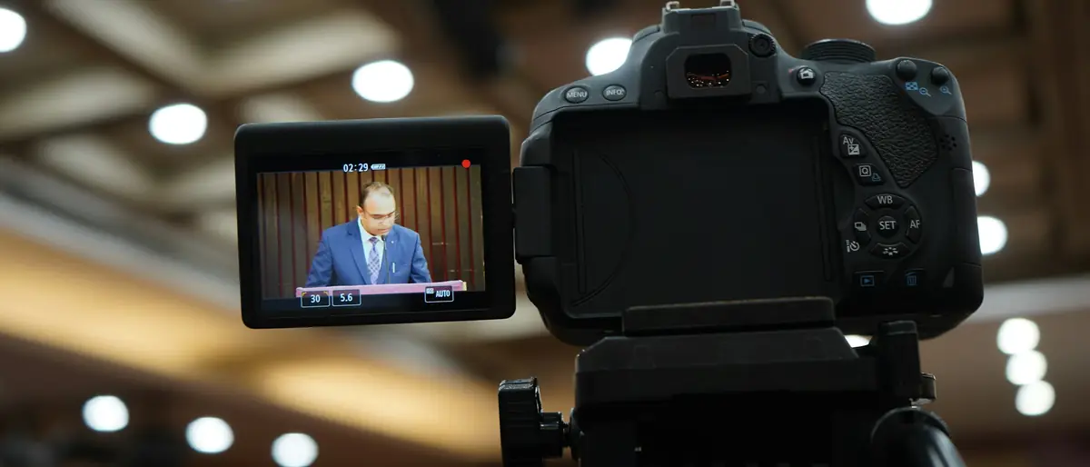 Κάμερα καταγράφει δήλωση ομιλητή σε αίθουσα